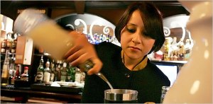 In this photo published by The New York Times, a confident Anushika Pradhan is seen tending bar at the Dublin Pub in the Maurya Sheraton Hotel in New Delhi, India.